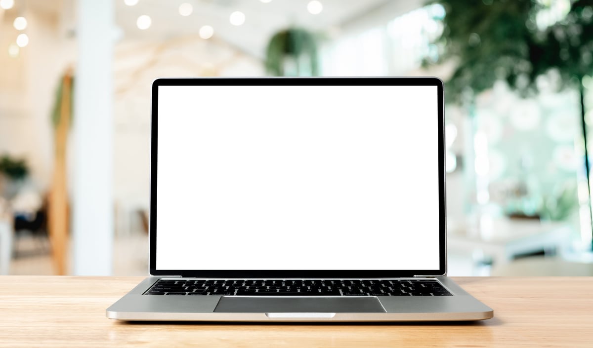 Laptop on wood table — simple kitchen table workspace