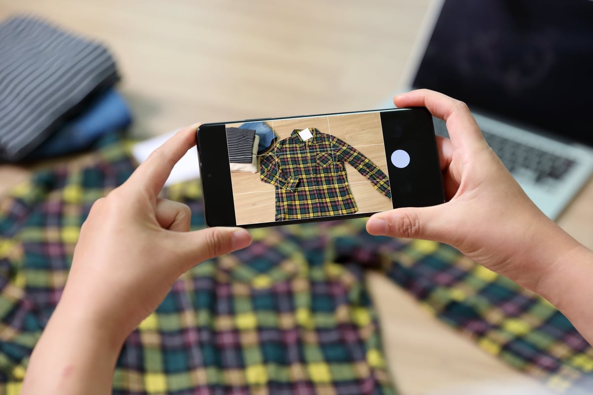 Person photographing clothes to sell online