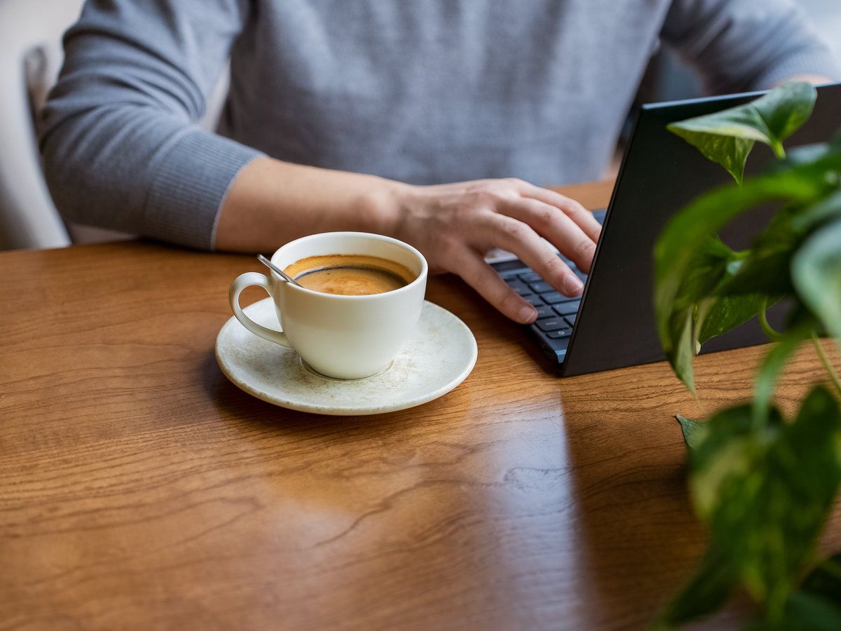 Kelley's workspace — laptop and coffee