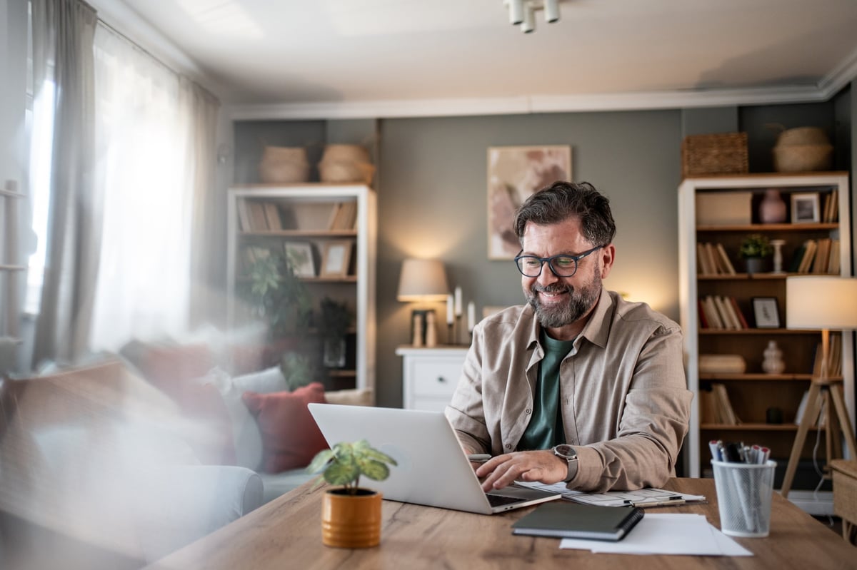 Happy person working from a cozy home office with warm, personal touches