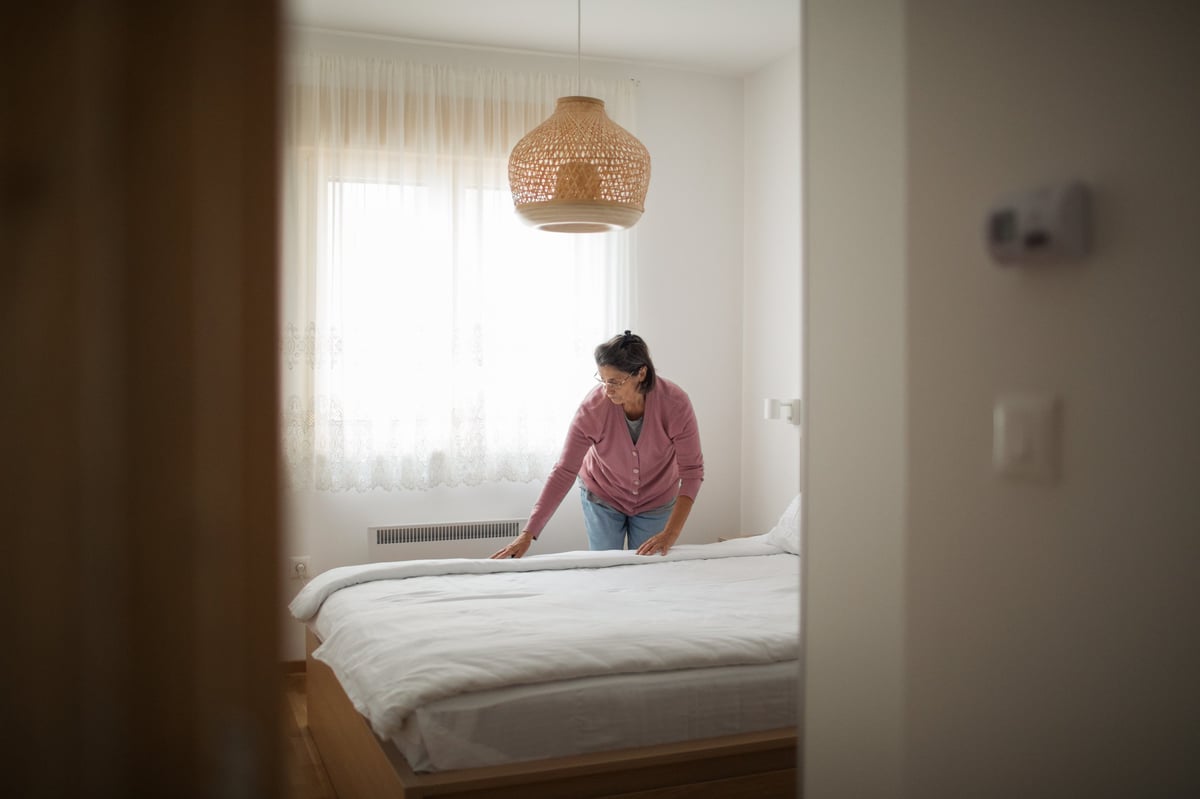 Person preparing room for rental or guest