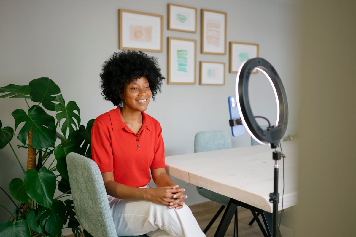 Person with ring light setup for video recording — even lighting for calls