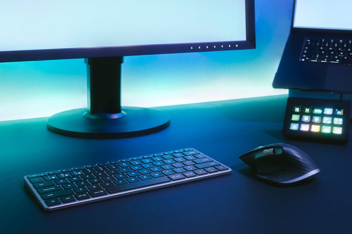 Sleek desk workspace with monitor and ambient blue bias lighting for eye comfort