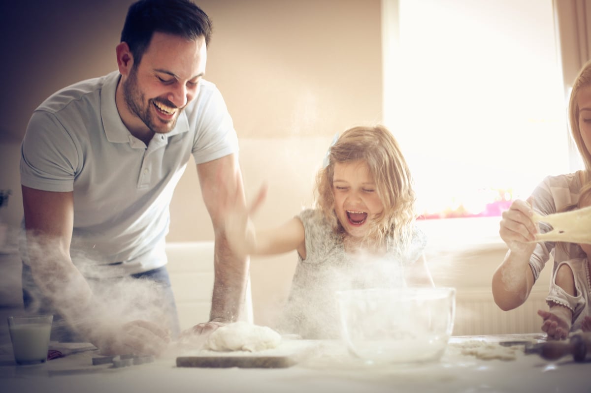 Family cooking and baking together in kitchen